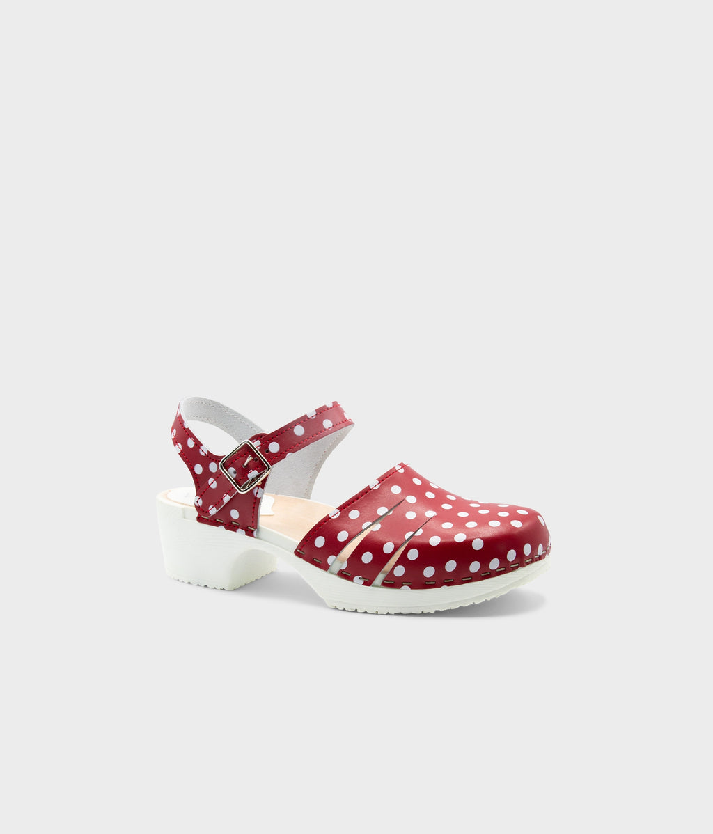 Red polka dot clog shoe on a light gray background